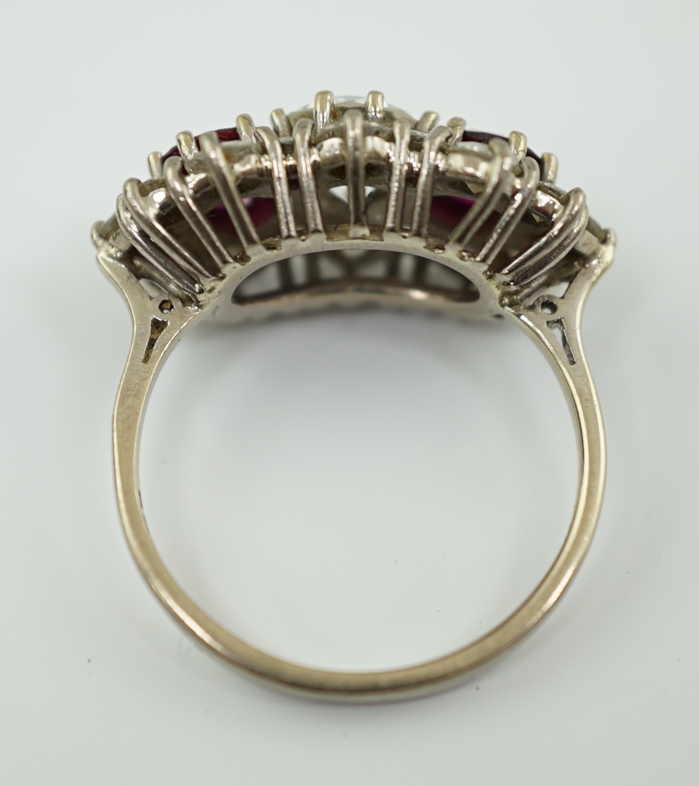 A 1970's 18ct white gold, ruby and diamond set triple cluster dress ring